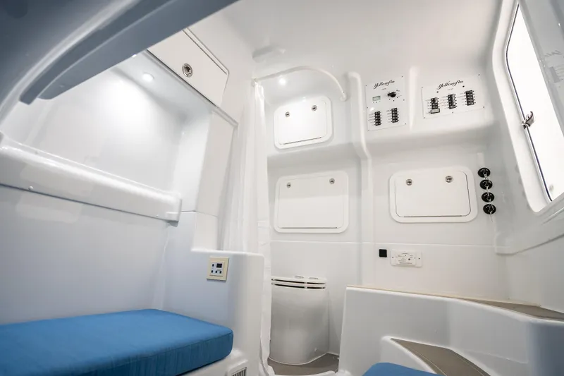 Slide: The Image of Interior of 2026 Yellowfin 42 Offshore boat with modern amenities and blue seating. - 33