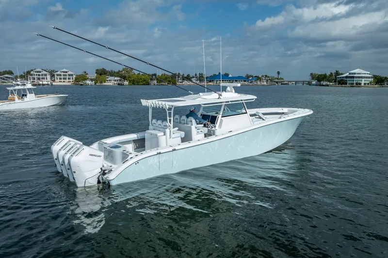 Slide: The Image of 2026 Yellowfin 42 Offshore boat with multiple engines on a calm waterway. - 5