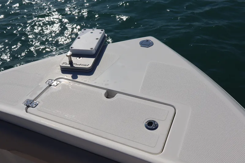 Slide: The Image of Bow of 2017 Sailfish 320 CC boat with anchor hatch, on sparkling water. - 10