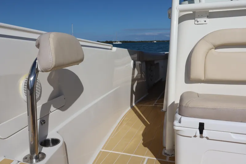 Slide: The Image of 2017 Sailfish 320 CC boat interior with beige seating and ocean view. - 15