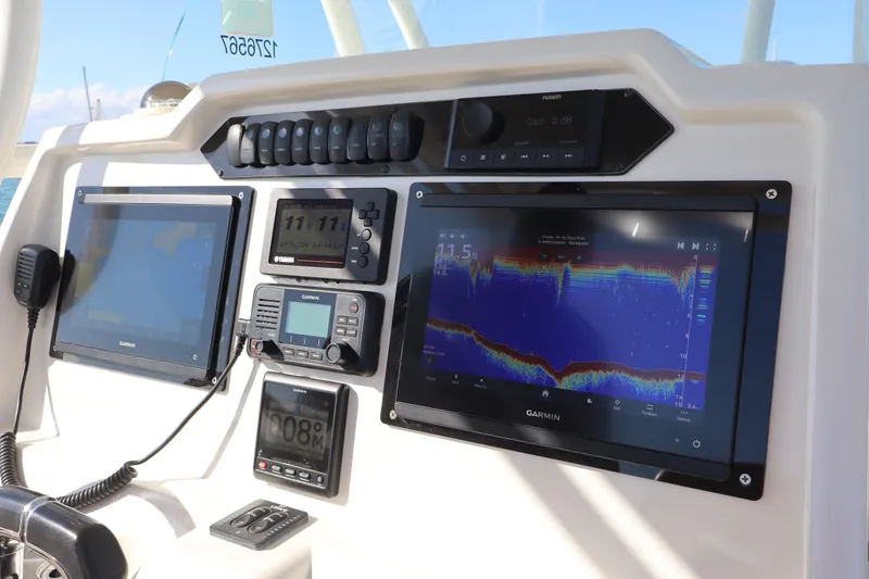 Slide: The Image of 2017 Sailfish 320 CC dashboard with Garmin navigation and control systems. - 17