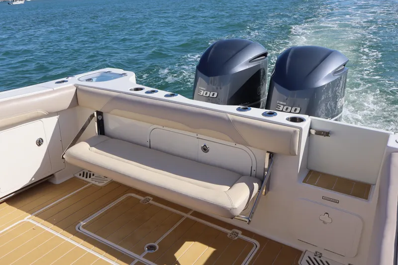 Slide: The Image of 2017 Sailfish 320 CC boat with twin Yamaha 300 engines on open water. - 22