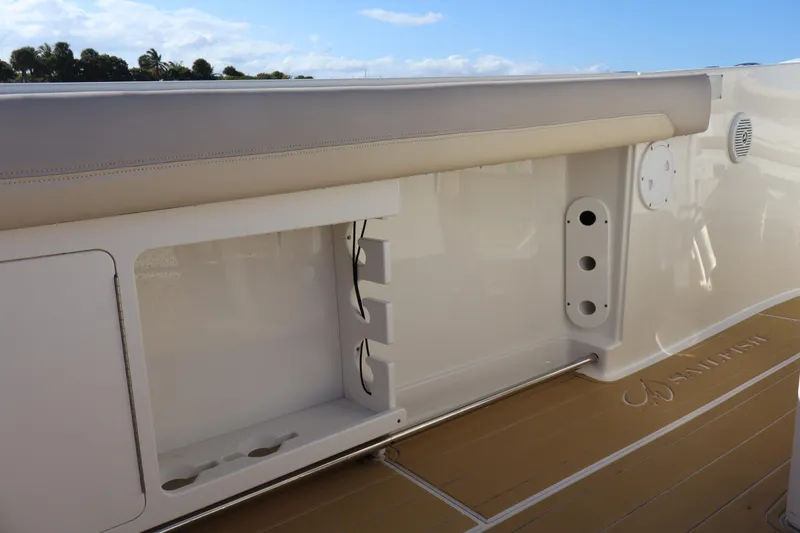 Slide: The Image of 2017 Sailfish 320 CC boat interior with storage compartment and cushioned seating. - 24