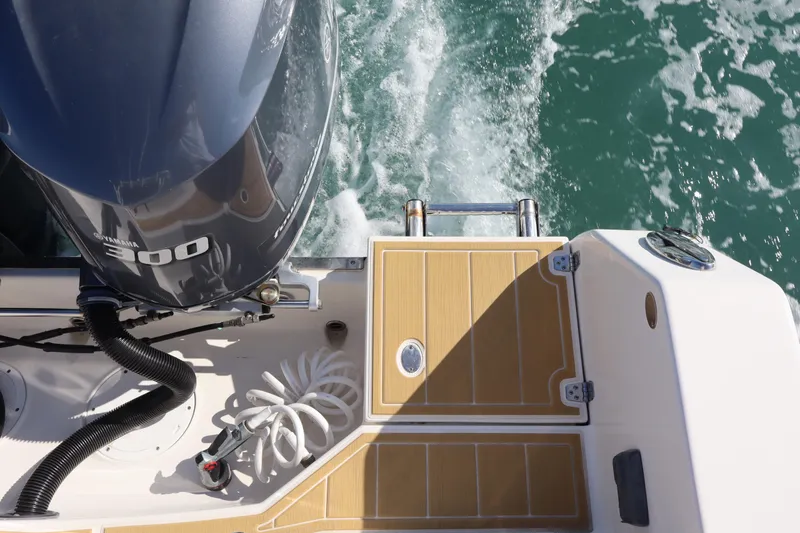 Slide: The Image of 2017 Sailfish 320 CC boat with Yamaha 300 engine on water. - 27