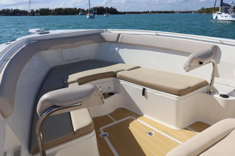 Slide: The Image of 2017 Sailfish 320 CC boat interior with cushioned seating and ocean view. - 6