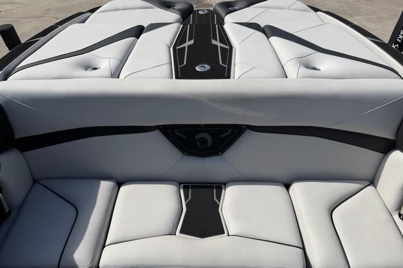 Slide: The Image of 2026 Centurion Nv233 boat interior with sleek white and black seating design. - 12