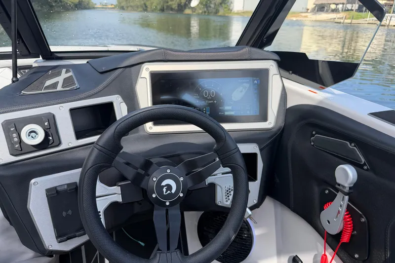 Slide: The Image of Interior of 2026 Centurion Nv233 boat with modern steering and digital display. - 13