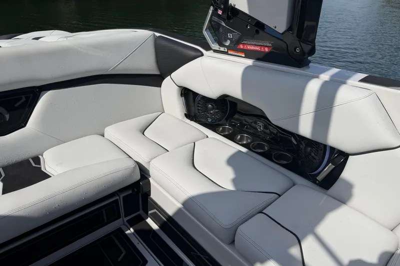 Slide: The Image of Luxurious seating area on 2026 Centurion Nv233 boat with cup holders and speakers. - 15