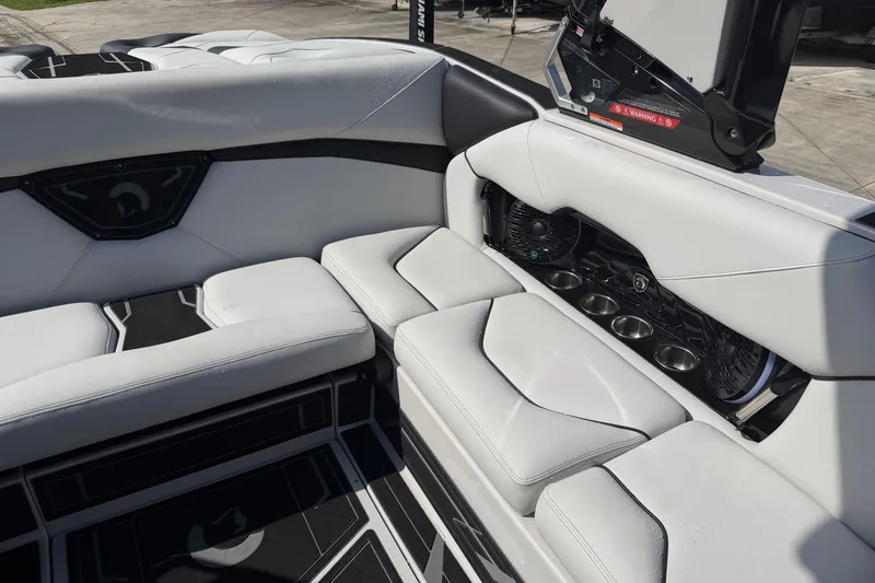 Slide: The Image of Luxurious interior of 2026 Centurion Nv233 boat with white seating and cup holders. - 17