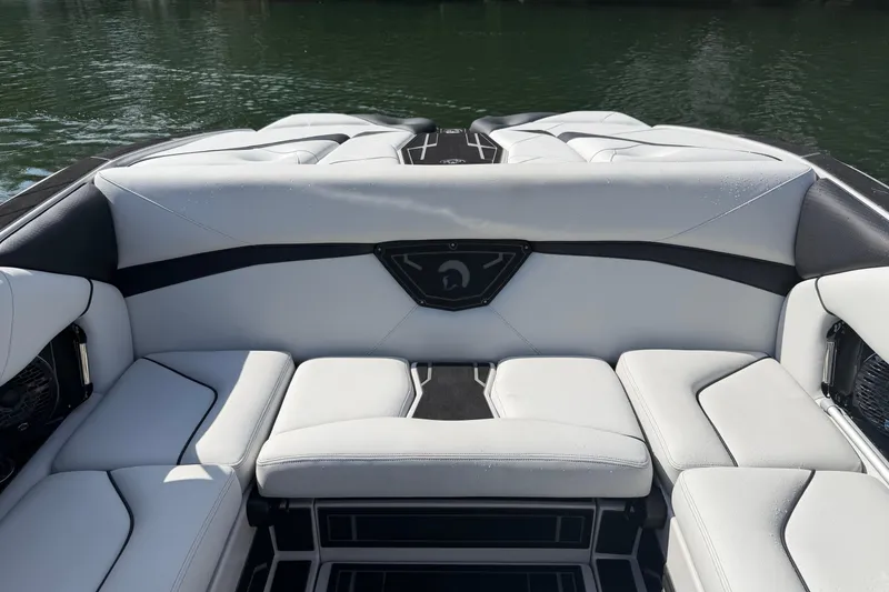 Slide: The Image of 2026 Centurion Nv233 boat interior with sleek white seating and black accents. - 24