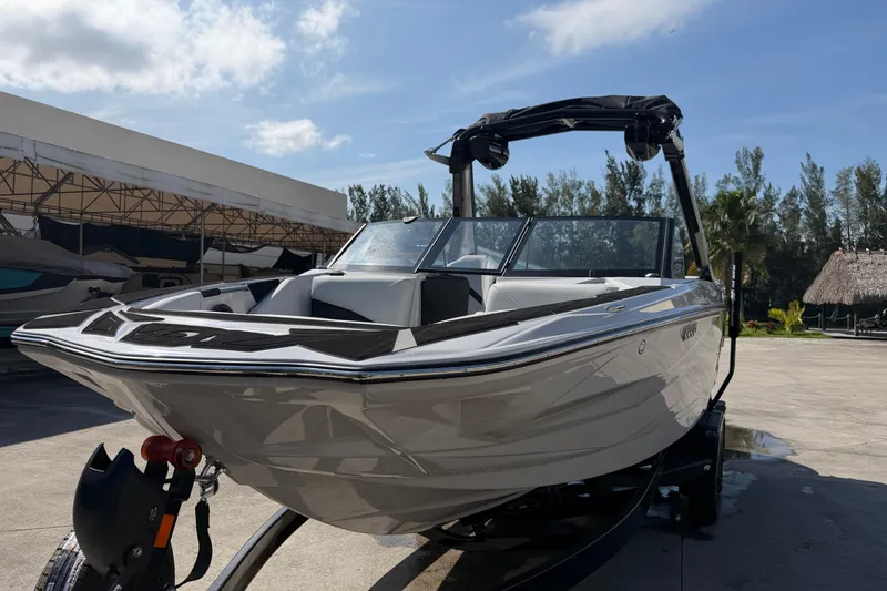 Slide: The Image of 2026 Centurion Nv233 boat on trailer under clear sky, parked outdoors. - 3