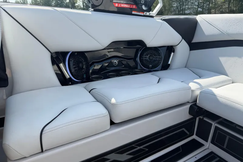 Slide: The Image of 2026 Centurion Nv233 boat interior with sleek white seating and integrated speakers. - 9