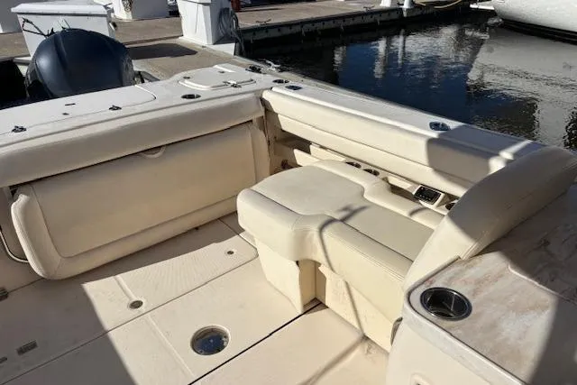 Slide: The Image of 2016 Grady-White Freedom 307 boat interior with seating and dual outboard motors. - 13