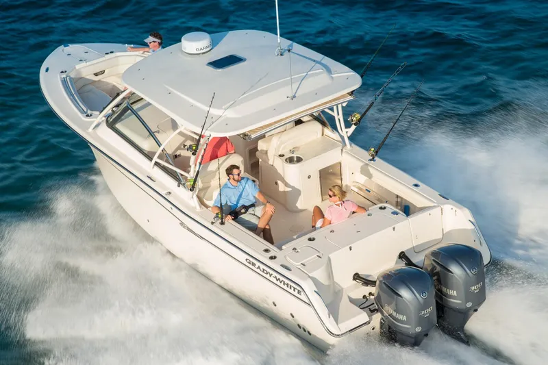 Slide: The Image of 2016 Grady-White Freedom 307 boat helm with plush seating and steering wheel. - 4