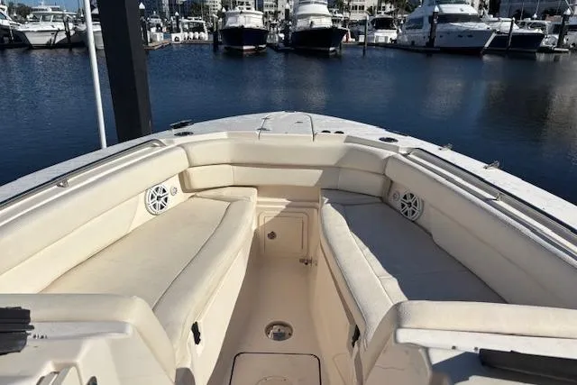 Slide: The Image of 2016 Grady-White Freedom 307 boat interior with helm, sink, and seating area. - 8