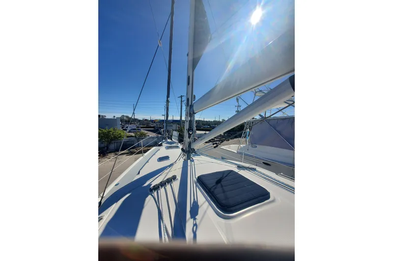 Slide: The Image of Sailing yacht Hunter 426 Deck Salon 2003, sunlit deck view with sails and rigging. - 10