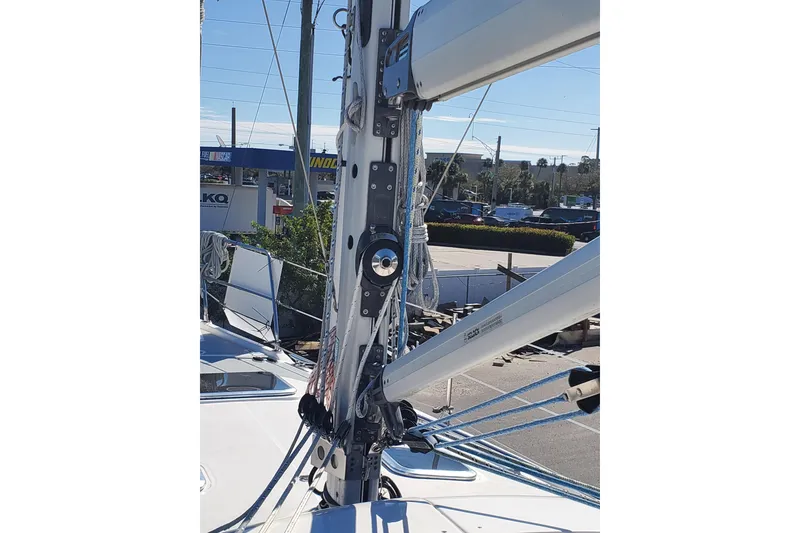 Slide: The Image of Hunter 426 Deck Salon 2003 sailboat mast and rigging in a marina setting. - 12