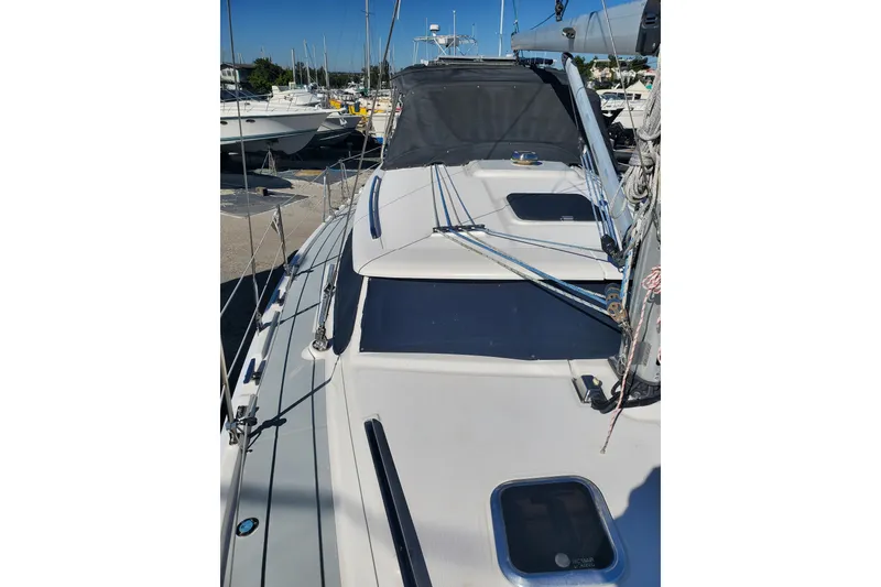 Slide: The Image of 2003 Hunter 426 Deck Salon sailboat, docked with visible rigging and deck features. - 14
