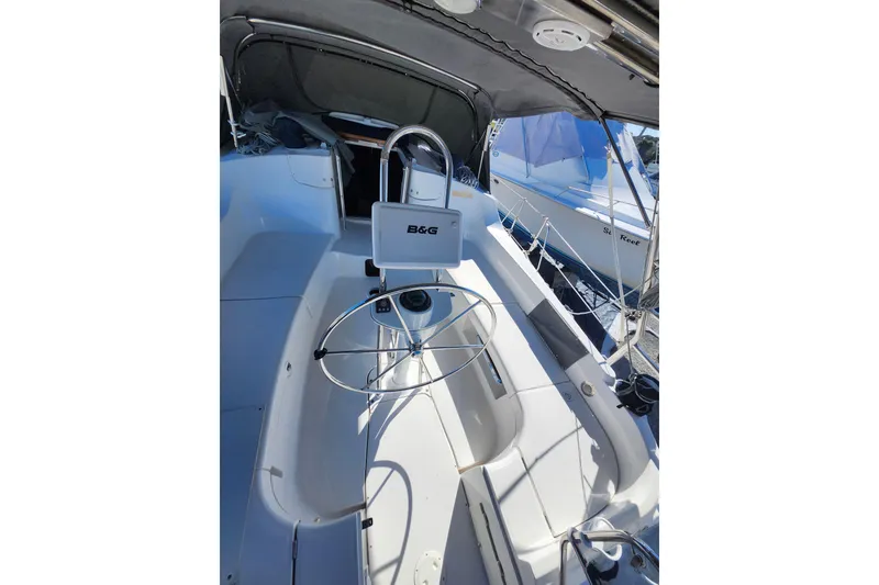 Slide: The Image of 2003 Hunter 426 Deck Salon cockpit with steering wheel and navigation equipment. - 19