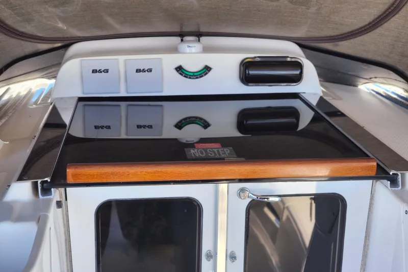 Slide: The Image of 2003 Hunter 426 Deck Salon cockpit with B&G instruments and "No Step" warning. - 25