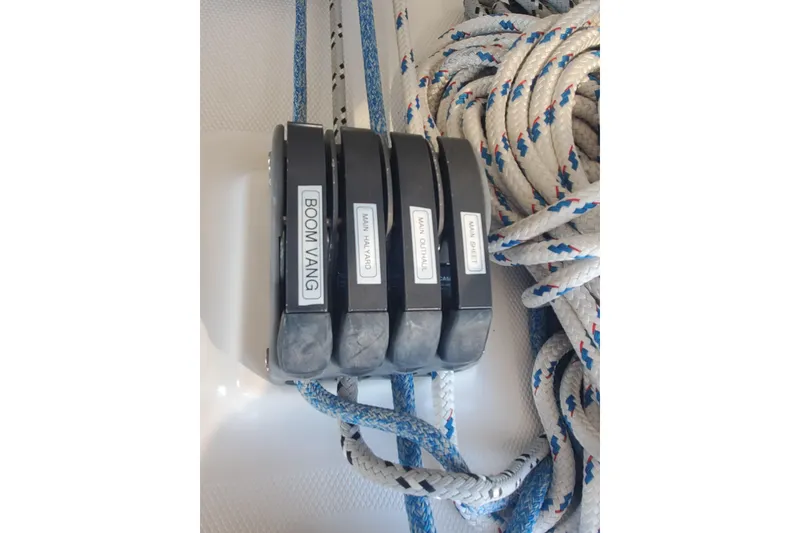 Slide: The Image of Rope clutches labeled "Boom Vang," "Main Halyard," "Main Outhaul," and "Main Sheet" on a 2003 Hunter 426 Deck Salon. - 36