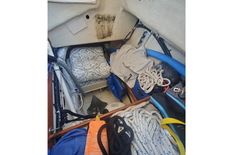 Slide: The Image of Interior of 2003 Hunter 426 Deck Salon with ropes and storage items. - 40