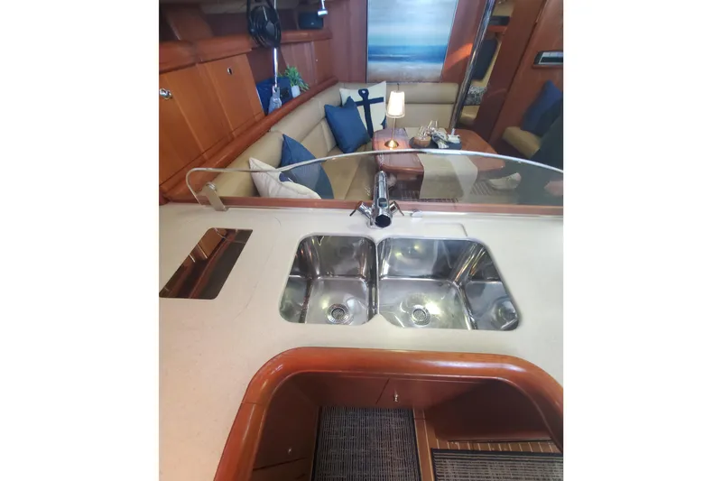 Slide: The Image of Interior of 2003 Hunter 426 Deck Salon with double sink and cozy seating area. - 47