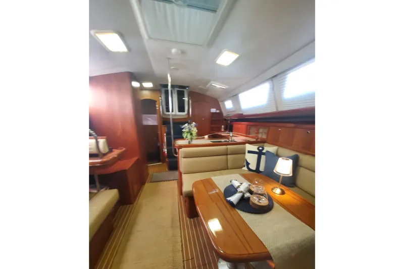 Slide: The Image of Interior of 2003 Hunter 426 Deck Salon yacht with elegant wood finish and cozy seating. - 51