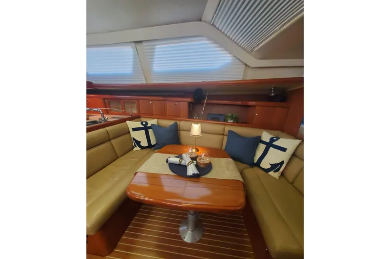 Slide: The Image of Luxurious interior of 2003 Hunter 426 Deck Salon with nautical-themed decor and cozy seating. - 52