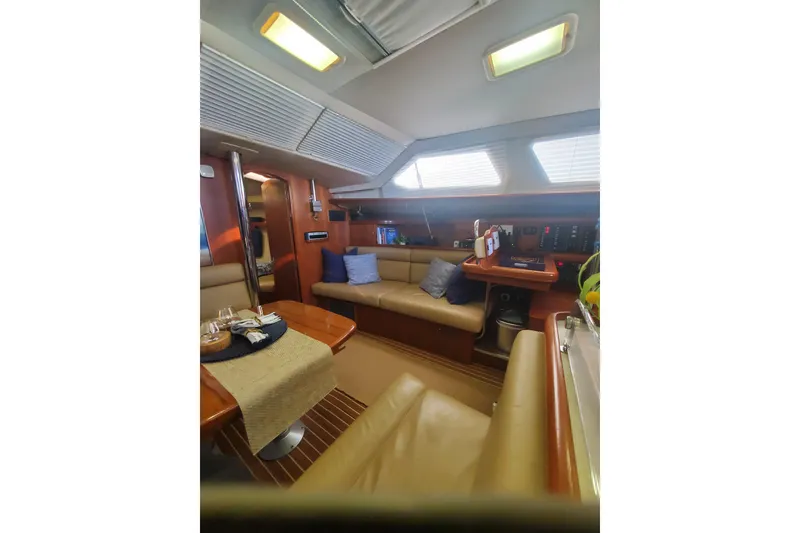 Slide: The Image of Interior of 2003 Hunter 426 Deck Salon with cozy seating and wooden accents. - 53