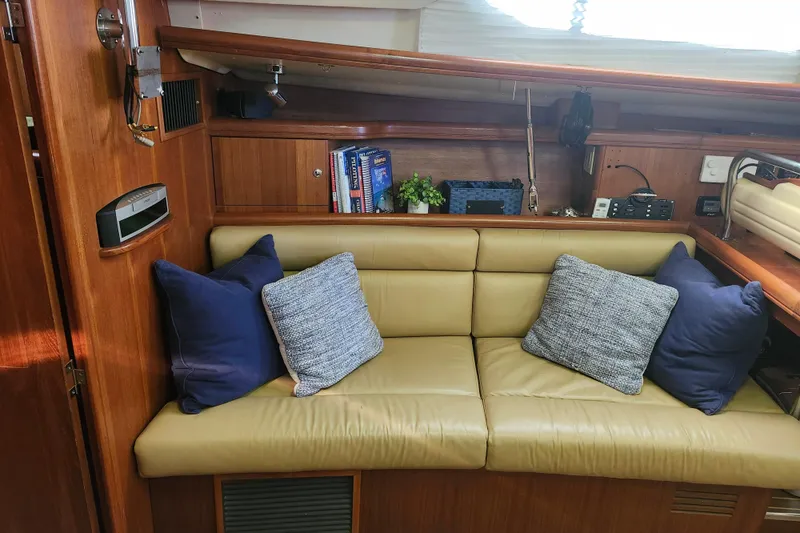 Slide: The Image of Interior of 2003 Hunter 426 Deck Salon with beige sofa and blue cushions. - 54