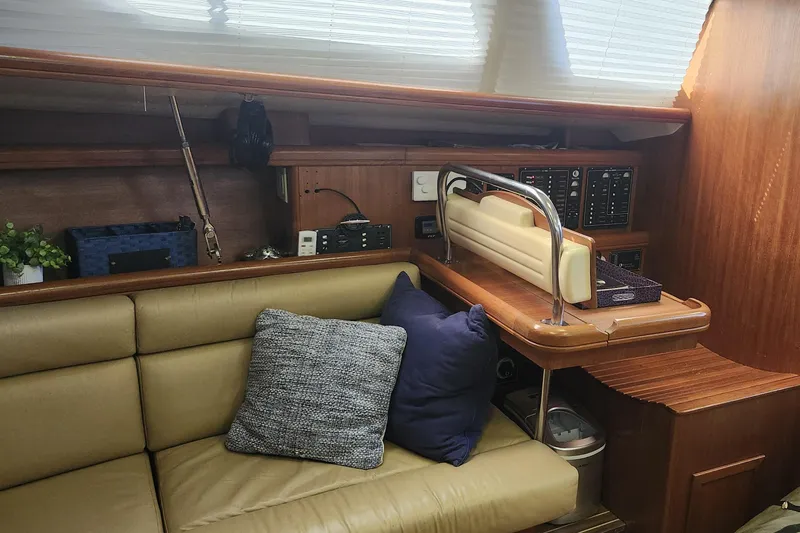 Slide: The Image of Interior of 2003 Hunter 426 Deck Salon with beige seating and wooden accents. - 55