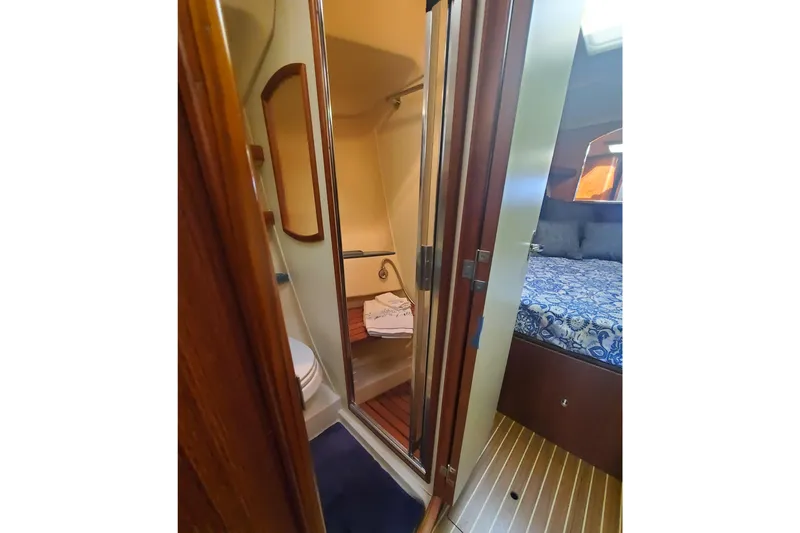 Slide: The Image of 2003 Hunter 426 Deck Salon interior with bathroom and cozy bedroom view. - 57