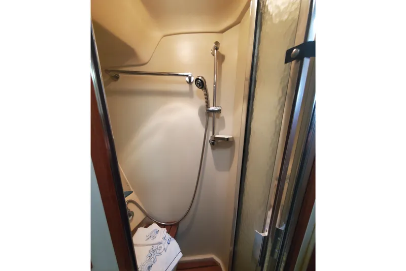 Slide: The Image of Shower area in 2003 Hunter 426 Deck Salon yacht with glass door and towel. - 58