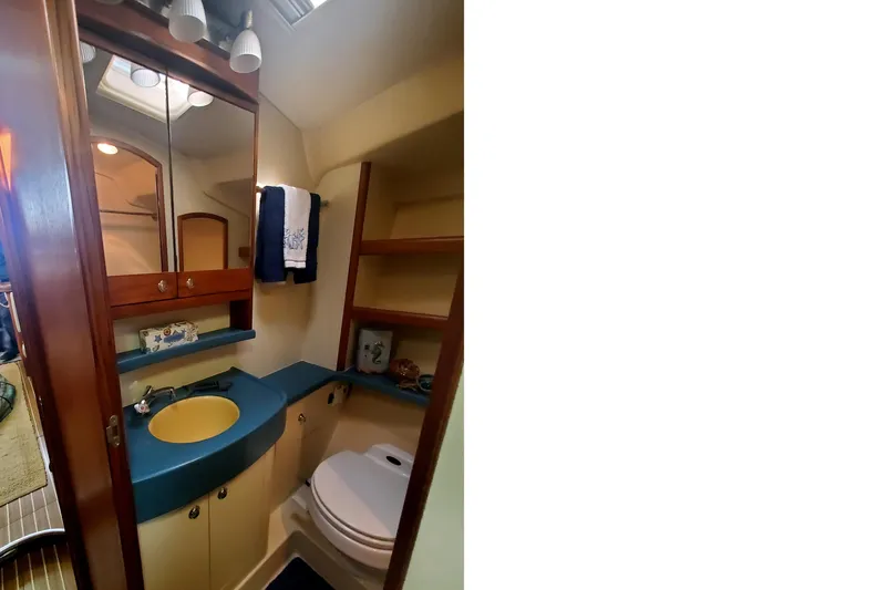 Slide: The Image of 2003 Hunter 426 Deck Salon bathroom with blue countertop and yellow sink. - 59