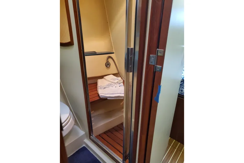 Slide: The Image of Shower area in 2003 Hunter 426 Deck Salon yacht with wooden accents and towels. - 60
