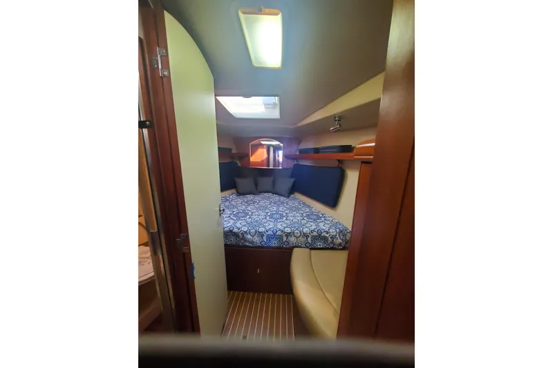 Slide: The Image of Interior cabin of 2003 Hunter 426 Deck Salon with cozy bed and wooden accents. - 62