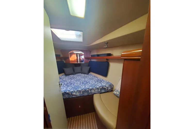 Slide: The Image of Interior of 2003 Hunter 426 Deck Salon with cozy bed and skylight. - 63