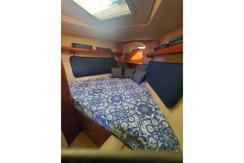 Slide: The Image of 2003 Hunter 426 Deck Salon interior cabin with patterned bedding and cushions. - 64