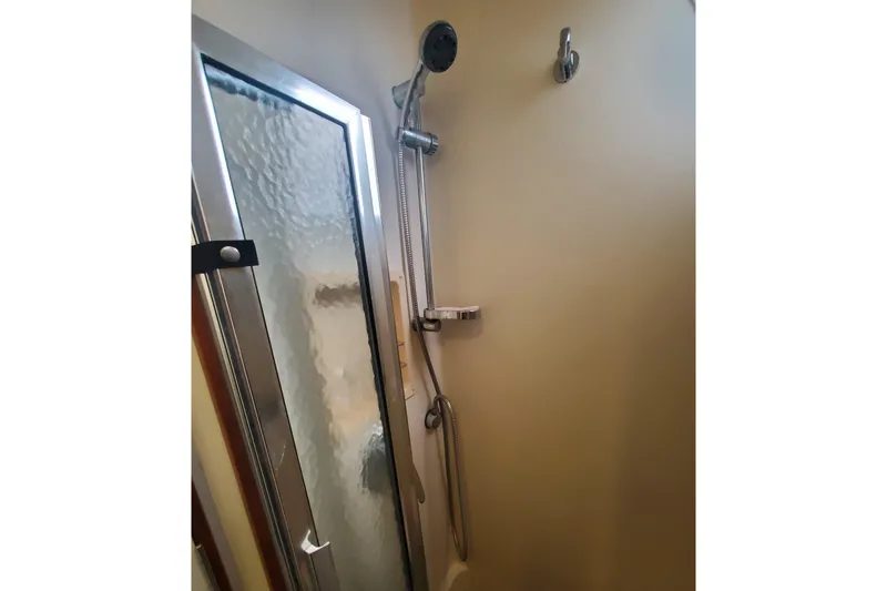 Slide: The Image of Shower area in 2003 Hunter 426 Deck Salon yacht with frosted glass door. - 69