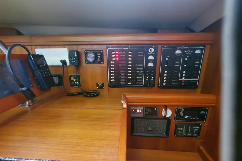 Slide: The Image of Control panel of a 2003 Hunter 426 Deck Salon yacht, featuring various switches and gauges. - 76