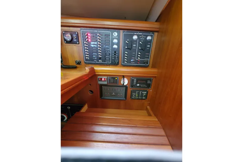 Slide: The Image of Control panel of 2003 Hunter 426 Deck Salon sailboat, featuring various switches and gauges. - 78