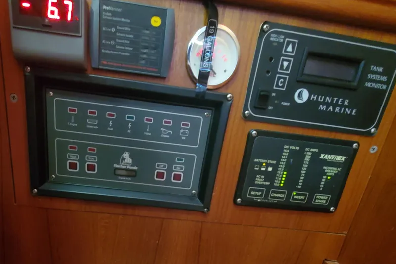 Slide: The Image of Control panel of a 2003 Hunter 426 Deck Salon sailboat with various monitoring systems. - 80