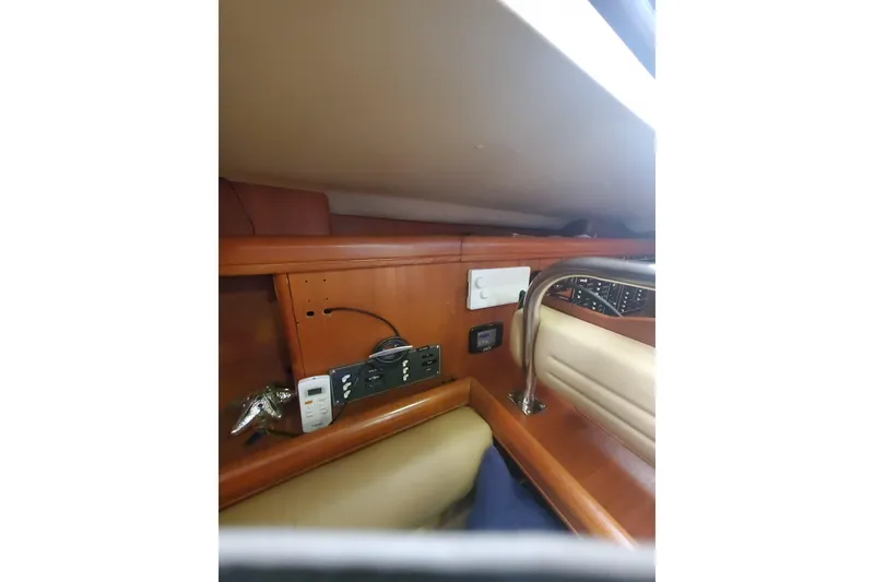 Slide: The Image of 2003 Hunter 426 Deck Salon interior with wooden cabinetry and electrical outlets. - 83