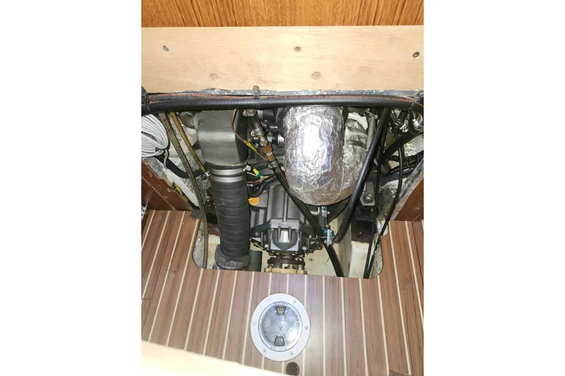 Slide: The Image of Engine compartment of 2003 Hunter 426 Deck Salon sailboat, showing mechanical components. - 91