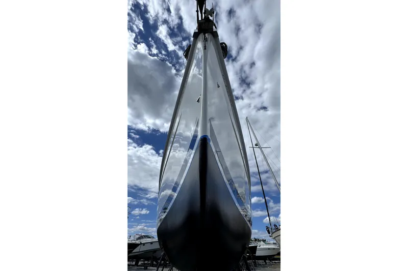 Slide: The Image of 2003 Hunter 426 Deck Salon sailboat under cloudy sky, viewed from below. - 94