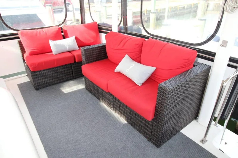 Slide: The Image of 1997 Cruisers Yachts 3650 Motoryacht interior with red cushioned wicker seating. - 14