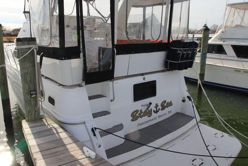 Slide: The Image of 1997 Cruisers Yachts 3650 Motoryacht docked, featuring "Stay n Sea" name on stern. - 2