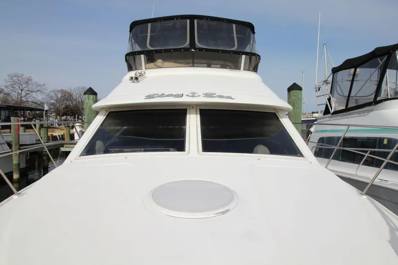 Slide: The Image of 1997 Cruisers Yachts 3650 Motoryacht docked at marina, front view. - 10