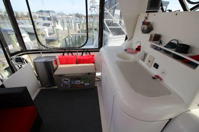 Slide: The Image of 1997 Cruisers Yachts 3650 Motoryacht interior with seating, kitchenette, and marina view. - 15